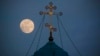 Crimea, Yevpatoriia - A supermoon rises behind the cross of the Saint Nicholas cathedral in Yevpatoriia, 31Jan2018